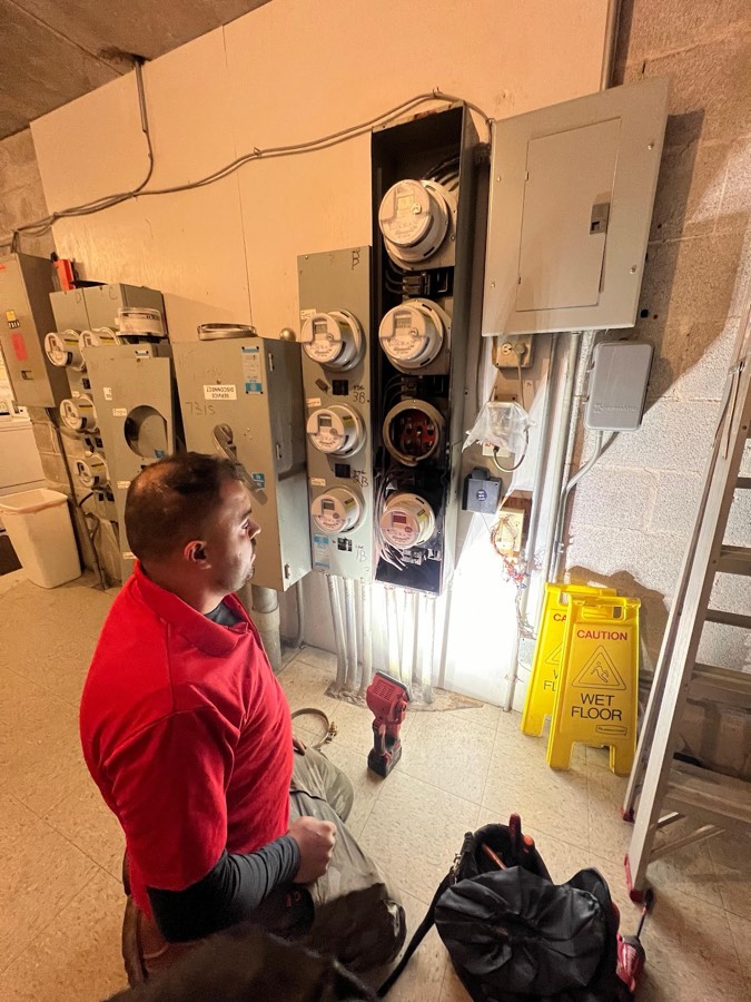Rescue Electric electrician servicing a multi-unit apartment meter bank